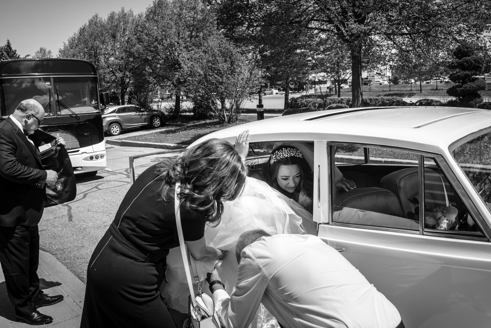 the bride is getting out of the car 