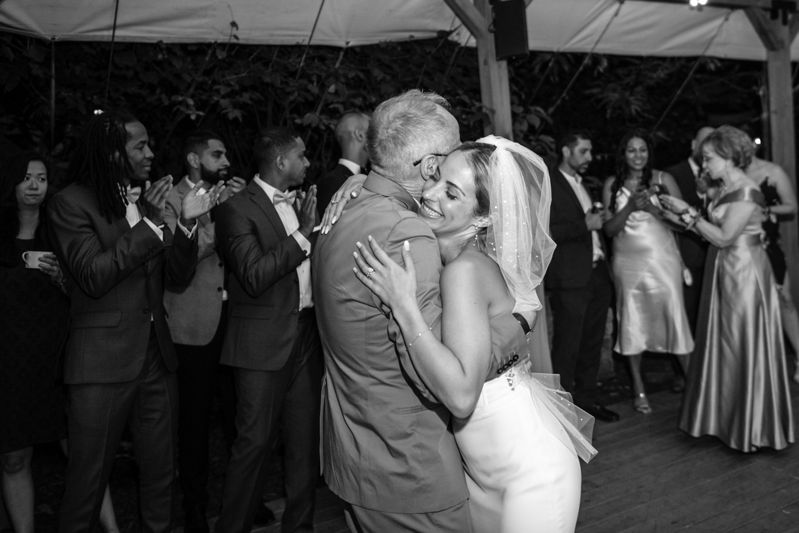 the bride is hugging her father when doing the first dance