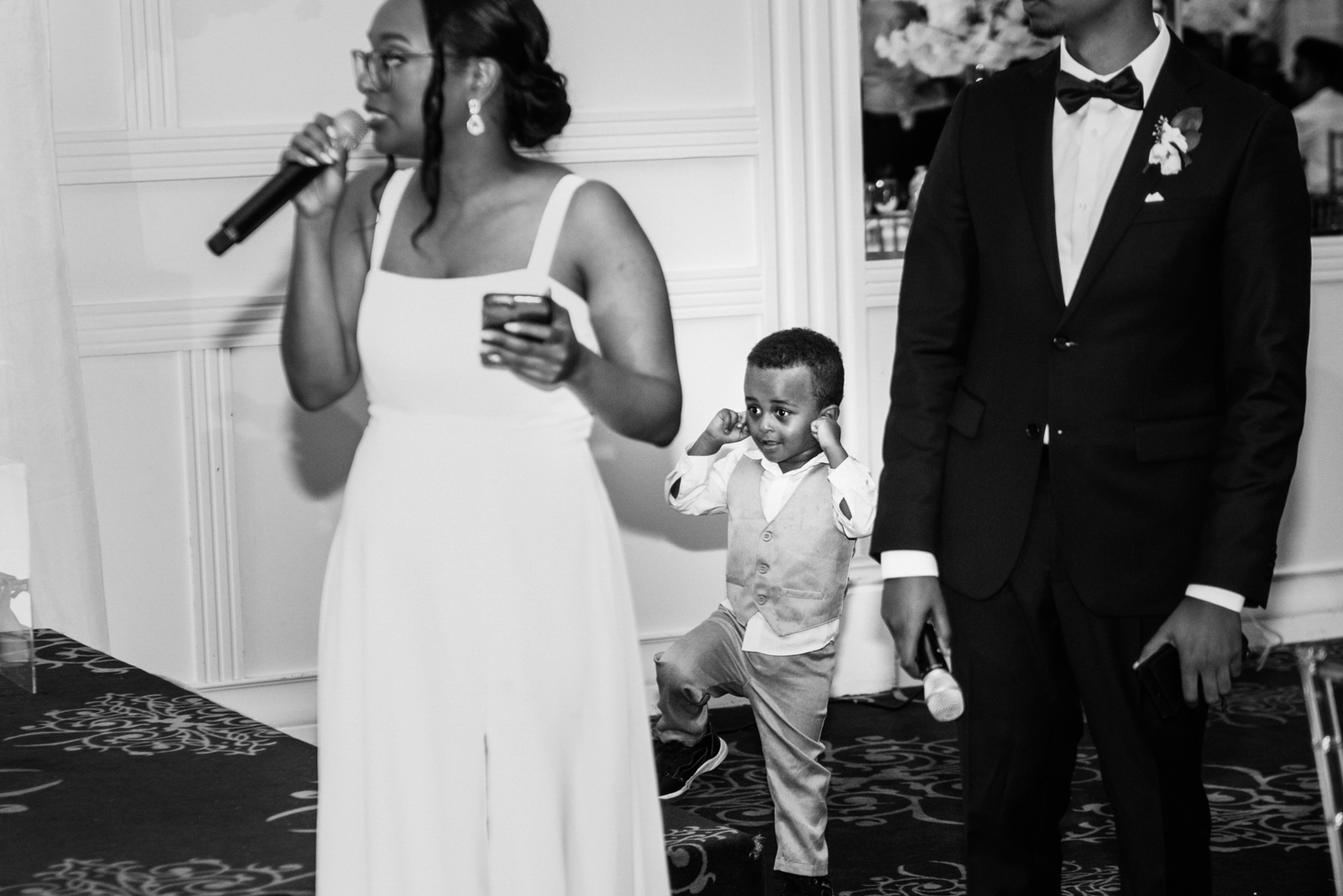 a little kid plugged his ears while the bridesmaid was giving speech on wedding reception