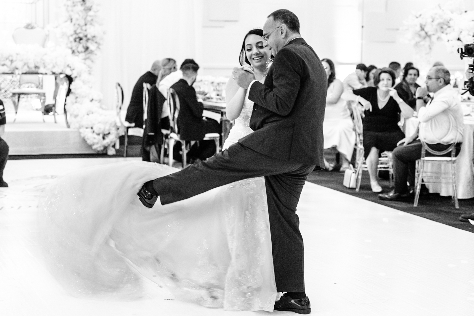 bride and her father are dancing on the dancing floor