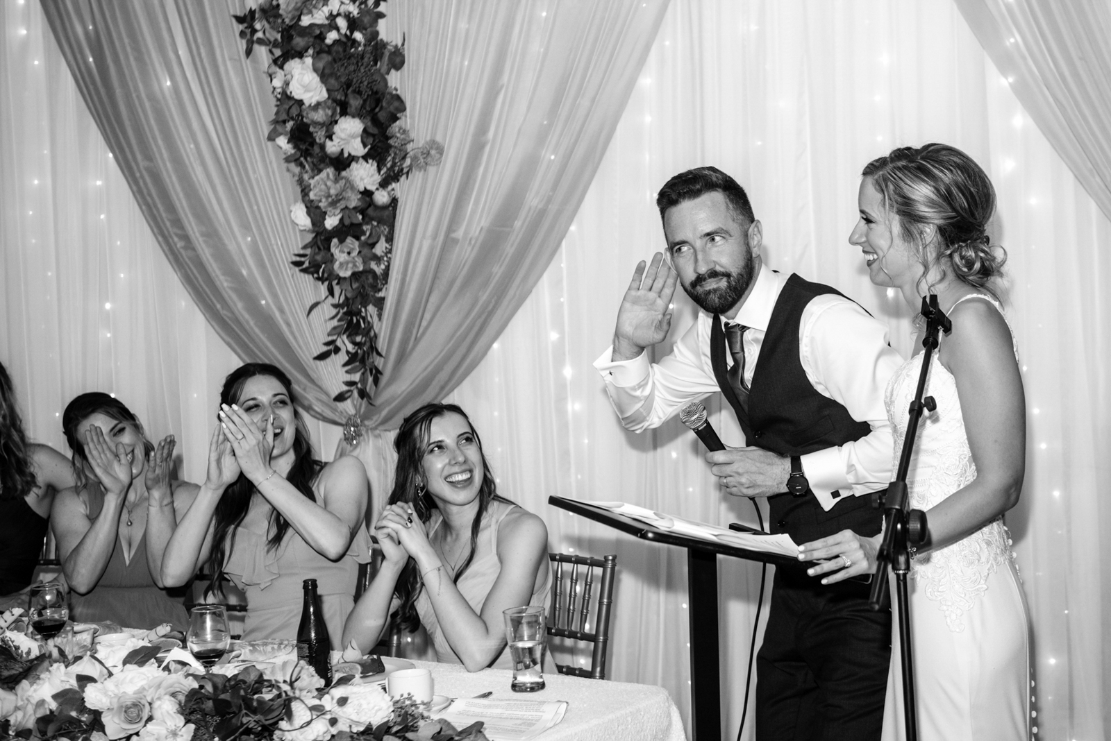 the groom is acting a funny action when giving his speech