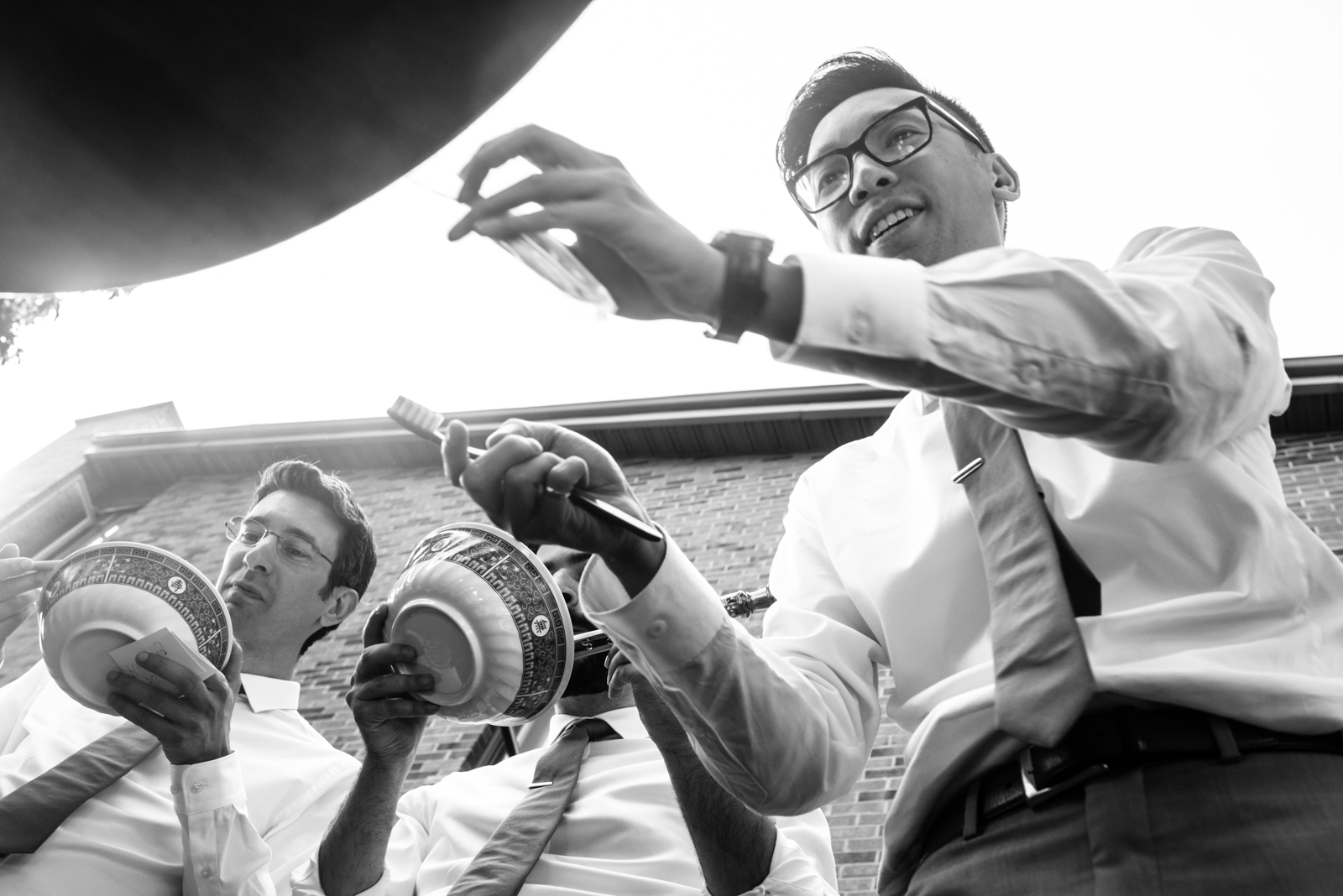 candid moment of groomsmen play door game at Chinese Wedding taken by documentary wedding photographer cafa liu